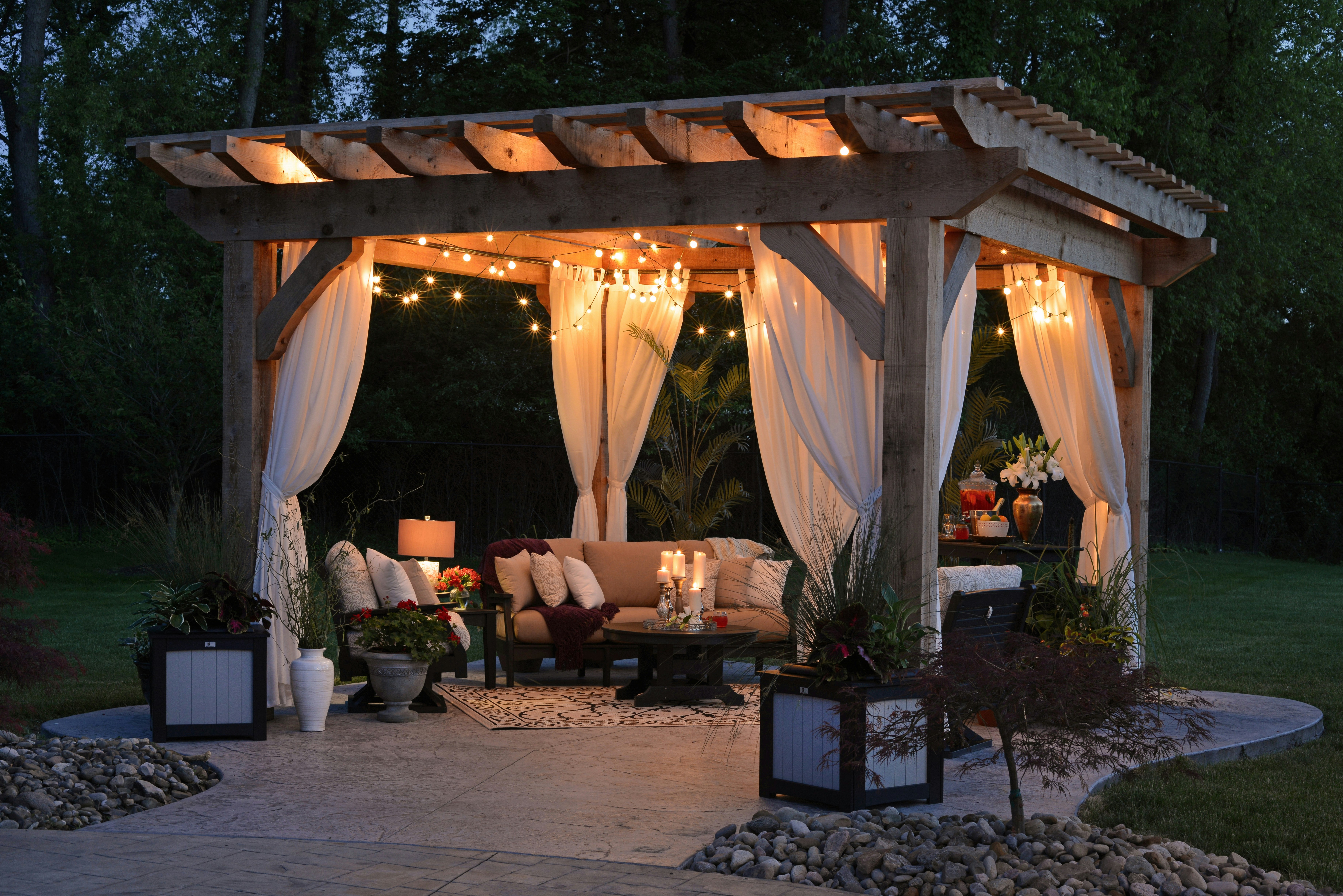 A large wooden pergola on a backyard patio.